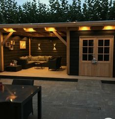 an outdoor living area is lit up at night