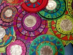 many colorful plates are arranged together on the table