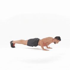 a man is doing push ups on one leg while holding a red object in the other hand