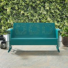 a green bench sitting next to a potted plant