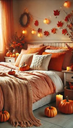 a bedroom decorated for fall with pumpkins and candles