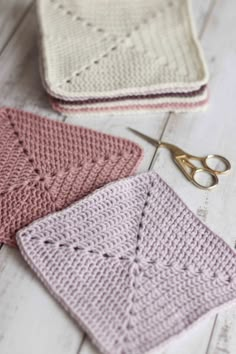 crocheted dishcloths with scissors on the table