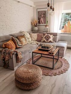 a living room filled with furniture and pillows