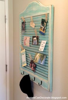 a wall hanging with pictures and magnets on it, next to a hat rack