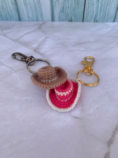 a crocheted keychain with a hat on it