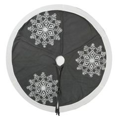 a black and white snowflake design on the side of a round table cloth