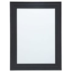 a black framed mirror on a white wall