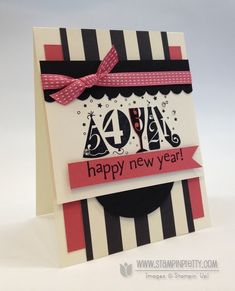 a happy new year card with black and white stripes, pink ribbon and red bow