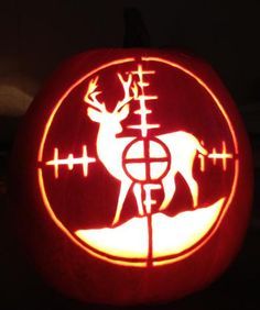 a carved pumpkin with an image of a deer and cross marks in the center on it