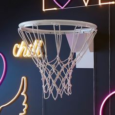 a basketball hoop hanging from the side of a wall with neon lights on it and love signs above