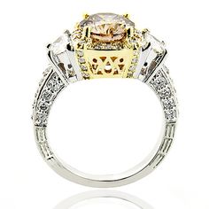 This Unique Champagne Fancy Color Diamond Engagement Ring in 18K gold by LUXURMAN features a halo design and showcases a beautiful 1 1/2 -carat natural fancy champagne diamond in the center and 1 carat of sparkling round and half moon shaped diamonds on the sides. Featuring a luxurious design and a 2 tone highly polished gold finish, this magnificent and unique diamond engagement ring is simply irresistible, and is available in 18K white, yellow and rose gold. Manufacturing time 5-7 business day Fancy Champagne, Month Gemstones, Yellow Diamonds Engagement, Yellow Diamond Engagement Ring, Unique Diamond Engagement Rings, Platinum Diamond Engagement Rings, Simply Irresistible, Halo Design, Diamond Engagement Ring Set