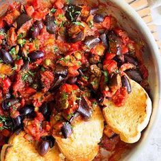 a bowl filled with bread and lots of vegetables