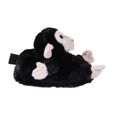 a black and white monkey slipper is laying on its back with it's paws up