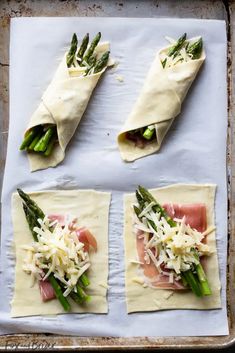 asparagus, ham and cheese wrapped in bread on a baking sheet ready to go into the oven