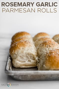 homemade rosemary garlic parmesan rolls on a baking sheet with text overlay that reads rosemary garlic parmesan rolls