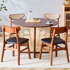 two chairs and a table with food on it in a room that has white carpet