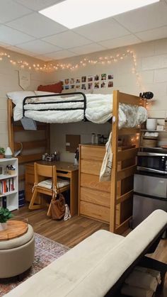 a loft bed sitting in the middle of a living room next to a desk and bookshelf