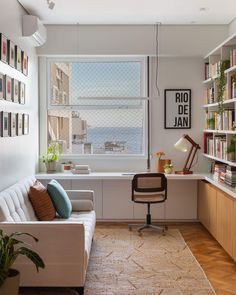 a living room filled with furniture and bookshelves next to a window covered in pictures