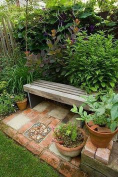 a wooden bench sitting in the middle of a garden