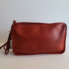 "Original Classic Coach Basic Bag Red leather with brass hardware Roomy interior with zip pocket secured by a top zipper Measures: 11\"L, 7\"H, 1.5\"W Detachable 33\" double strap Made in the New York City, USA Glue in serial #484-8121 Hooks have anchor stamp Flaw: slight discoloration on hardware and patina normal with age Cleaned, conditioned and ready to wear Questions? just ask more vtg coach styles/colors also available G46" Classic Red Shoulder Bag With Zipper Closure, Red Leather Satchel With Zipper Closure, Red Leather Bag With Zipper Pouch, Classic Burgundy Shoulder Bag With Zipper Closure, Formal Crossbody Shoulder Bag With Zipper, Red Leather Satchel With Zipper Pocket, Red Clutch Shoulder Bag With Zipper Closure, Classic Red Bag With Zipper Pocket, Classic Red Bags With Zipper Pocket