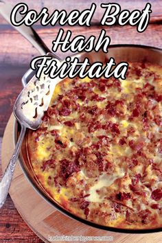 a close up of a pizza in a pan on a wooden table with the words corned beef hash frittata