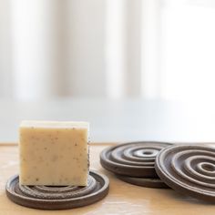 a bar of soap sitting on top of coasters next to each other with circles around it