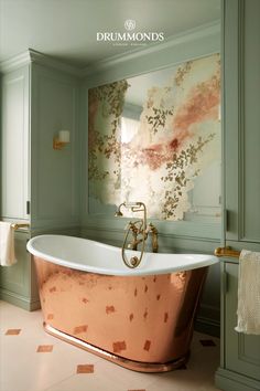 a bathroom with a copper bathtub and green walls