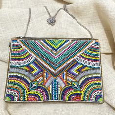 "Modern Marrakesh Bohemian Seed Beaded Clutch Bag Crossbody Handbag * Beaded Bag * Standard Bag Size: 11\" L X 8\" W  * Chain Strap: 48\" Detachable * 100% Cotton * One Inside Slip Pocket * Reinforced Magnetic Snap Closure" Traditional Beaded Clutch Bag, Bohemian Multicolor Clutch Pouch, Beaded Festival Clutch Bag, Festival Beaded Clutch Bag, Beaded Clutch Bags For Festivals, Bohemian Beaded Clutch For Everyday Use, Bohemian Beaded Clutch For Festivals, Bohemian Beaded Pouch Clutch, Bohemian Clutch Shoulder Bag For Festivals