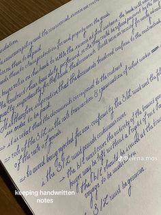 a close up of handwriting on top of a piece of paper with writing underneath it