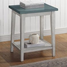 a white and blue end table with books on top