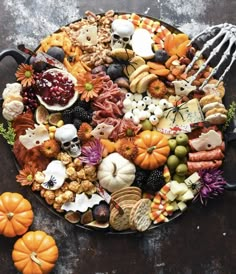 a platter filled with halloween food on top of a table next to a fork