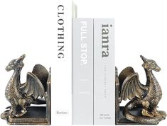 two bookends with metal dragon figurines next to each other