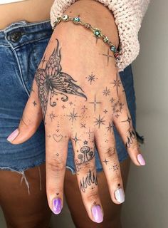 a woman's hand with tattoos on it