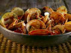 a pan filled with clams and sauce on top of a table