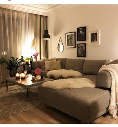 a living room filled with furniture and pictures on the wall