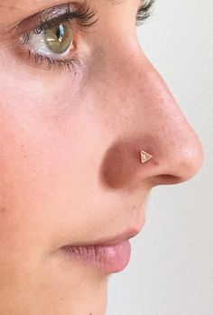 a close up of a person with a nose piercing on their left side of the face