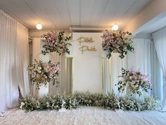 flowers and greenery are arranged on the floor in front of an entrance to a wedding reception