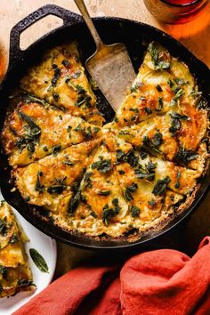 spinach and cheese pizza in a cast iron skillet