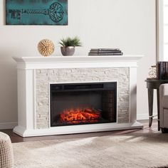 a living room with a fire place in the center and a painting on the wall