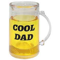 a glass mug filled with liquid that says cool dad