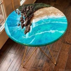 a table that has been made to look like the ocean with rocks and sand on it