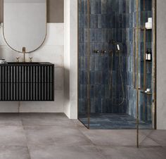 a bathroom with a sink, mirror and shower stall in it's center area