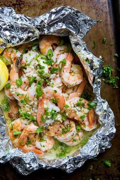 shrimp in foil with lemon wedges and parsley