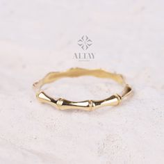 a close up of a gold ring on a white surface