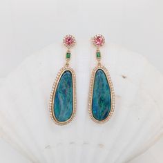 A stunning pair of earrings featuring gorgeous Boulder Opals bezel set in 14k solid yellow gold with a beautiful pink tourmaline and emerald accents. Colorful, elegant, classy, and a definite conversation starter! These earrings are made with solid 14k Gold and natural earth-mined SI / G-H Diamonds. As listed, these earrings are ready to ship. If you're interested in purchasing this setting with a different center stone please message us! Opal Drop Earrings, Jewelry Safe, Natural Earth, Boulder Opal, Solid Yellow, Pink Tourmaline, Estate Jewelry, Columbus, Tourmaline