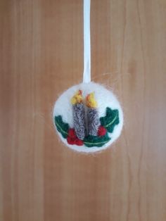 a felt ornament hanging from a wooden door