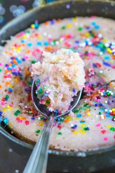 a cake with sprinkles and a spoon in it