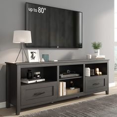 an entertainment center in a living room with a flat screen tv mounted on the wall