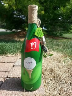 a green bottle with a golf ball on it