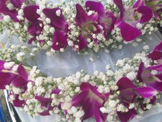 purple and white flowers are arranged on a table